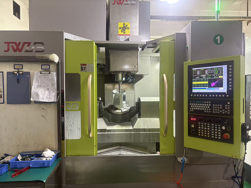 5-axis CNC machining center machining an aluminum audio control panel in one setup