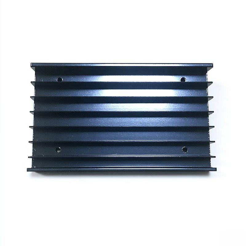 Black anodized heat sink with four drilled mounting holes