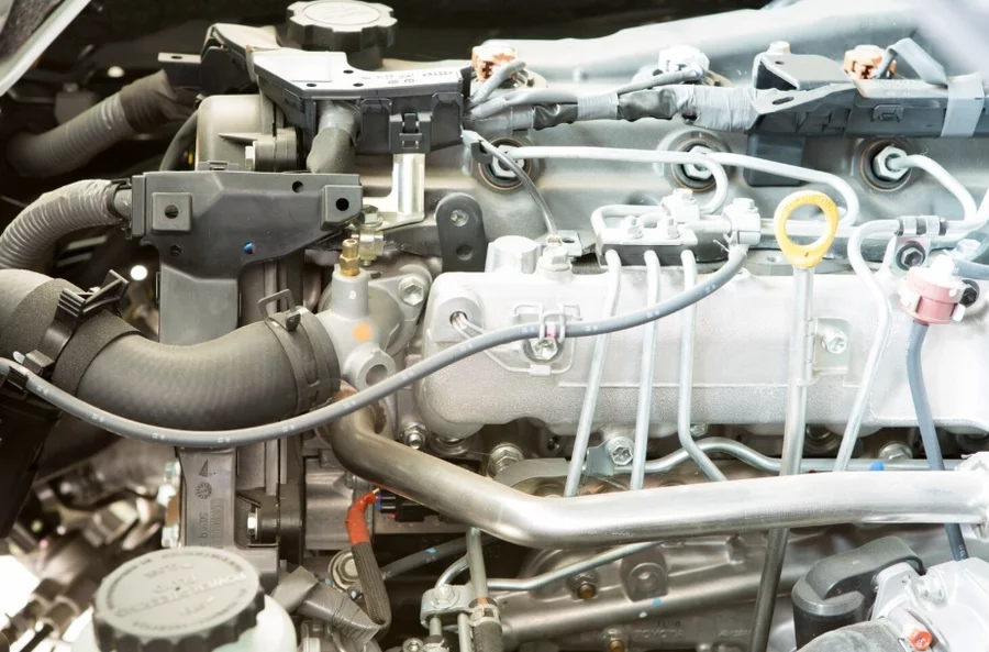 CNC machined stainless steel connectors and sealing faces in vehicle engine bay